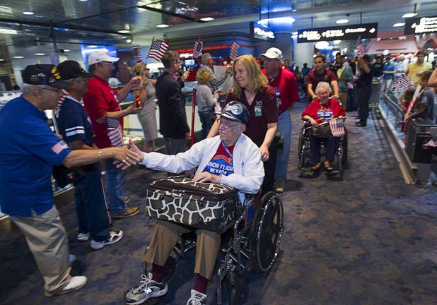 World War II veterans Jules Teck, 94, of Henderson, and Edna Filson, 93, of Boulder City, are welcomed back after the first Las Vegas Honor Flight at McCarran International Airport Sunday, May 5, 2013. About 35 Southern Nevada veterans visited Baltimore and memorials in Washington D.C.