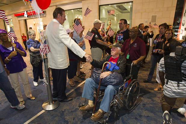 Former Governor Bob Miller, left greets World War II veterans after the first Las Vegas Honor Flight at McCarran International Airport Sunday, May 5, 2013. About 35 Southern Nevada veterans visited Baltimore and memorials in Washington D.C.
