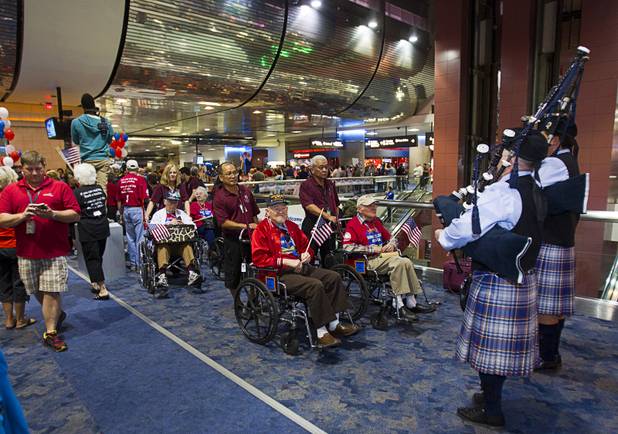 Bagpipers with the Desert Sky Pipe Band play for World War II veterans as they are welcomed back after the first Las Vegas Honor Flight at McCarran International Airport Sunday, May 5, 2013. About 35 Southern Nevada veterans visited Baltimore and memorials in Washington D.C.