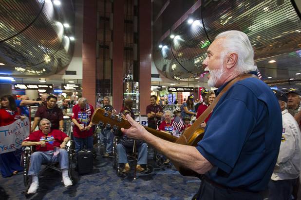 Phil Esser, right, performs for World War II veterans as they are welcomed back after the first Las Vegas Honor Flight at McCarran International Airport Sunday, May 5, 2013. About 35 Southern Nevada veterans visited Baltimore and memorials in Washington D.C.
