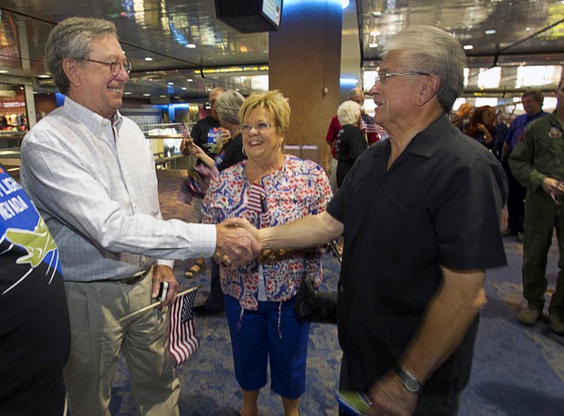 Former Governor Bob List, left, shakes hands with Las Vegas City Councilman Bob Coffin as they wait to welcome home World War II veterans after the first Las Vegas Honor Flight at McCarran International Airport Sunday, May 5, 2013. Coffin was also a member of the Nevada Assembly from 1983 through 1985. About 35 Southern Nevada veterans visited Baltimore and memorials in Washington D.C.