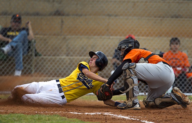 Chaparral Cowboys catcher Eduardo Jimenez tags out Austin Wishard at home plate during a playoff game against the Boulder City Eagles in Boulder City Tuesday, May 7, 2013.