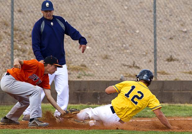 Chaparral's Chad Clark tags out Garrett Calloway at third base during a playoff game against the Boulder City Eagles in Boulder City Tuesday, May 7, 2013.