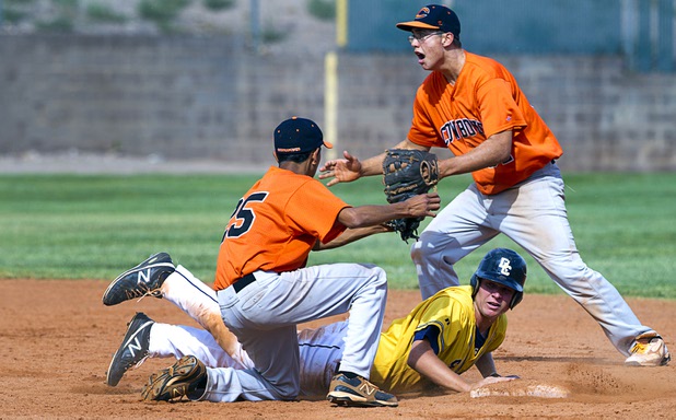 Chaparral Cowboys  second baseman Jerry Zendejas, left and shortstop Tommy Crone celebrate an out during a playoff game against the Boulder City Eagles in Boulder City Tuesday, May 7, 2013.