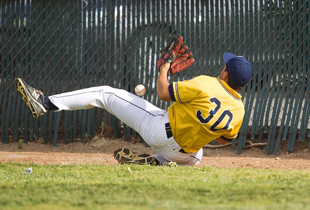 Boulder City outfielder Mario Castanon falls while trying to catch a fly ball during a playoff game against the Chaparral Cowboys in Boulder City Tuesday, May 7, 2013.