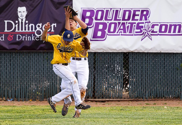 Boulder City outfielders nearly collide as they go for a fly ball during a playoff game against the Chaparral Cowboys in Boulder City Tuesday, May 7, 2013.