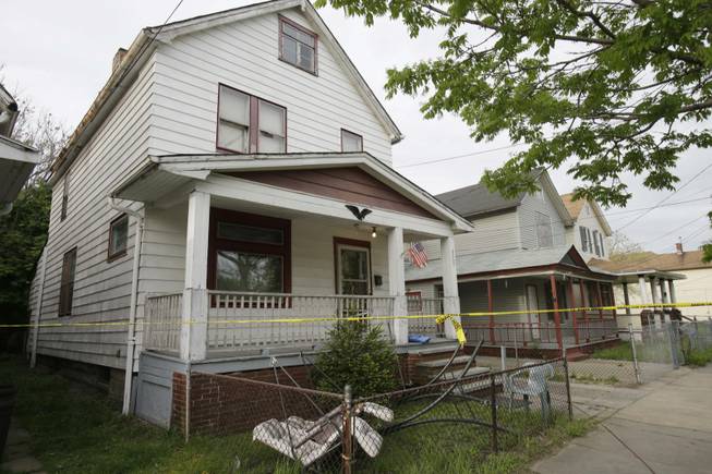 A house where three women escaped is shown Tuesday, May 7, 2013, in Cleveland. Amanda Berry, Gina DeJesus and Michelle Knight, who went missing separately about a decade ago, were found in the home just south of downtown Cleveland. 