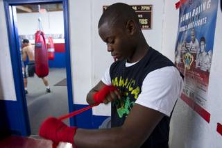 Mike McCallum Jr., a Silverado High School student, wraps his hands before a workout with his father at Johnny Tocco's Boxing Gym Thursday, May 9, 2013.  Mike McCallum Sr., known as the 