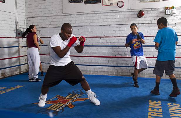 Mike McCallum Jr., a Silverado High School student, shadowboxes in a ring with other youth boxers at Johnny Tocco's Boxing Gym Thursday, May 9, 2013.  Mike McCallum Sr., known as the "Body Snatcher" for his fierce body punching, won world titles in three weight divisions.