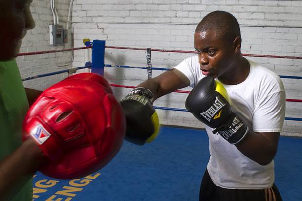 Mike McCallum Jr., a Silverado High School student, works on his timing with his father at Johnny Tocco's Boxing Gym Thursday, May 9, 2013.  Mike McCallum Sr., known as the "Body Snatcher" for his fierce body punching, won world titles in three weight divisions.