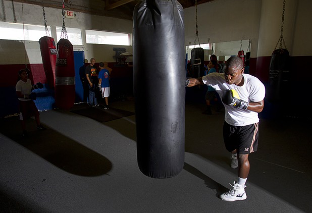 Mike McCallum Jr., a Silverado High School student, hits a heavy bag during a workout at Johnny Tocco's Boxing Gym Thursday, May 9, 2013.  Mike McCallum Sr., known as the "Body Snatcher" for his fierce body punching, won world titles in three weight divisions.