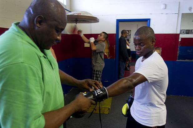 Mike McCallum Jr., a Silverado High School student, works out with his father at Johnny Tocco's Boxing Gym Thursday, May 9, 2013.  Mike McCallum Sr., known as the "Body Snatcher" for his fierce body punching, won world titles in three weight divisions.