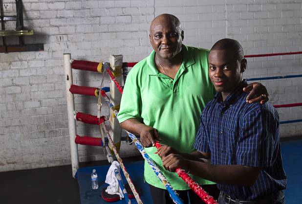 Mike McCallum Sr. poses with his son Mike McCallum Jr. at Johnny Tocco's Boxing Gym Thursday, May 9, 2013.  Mike McCallum Sr., known as the "Body Snatcher" for his fierce body punching, won world titles in three weight divisions.
