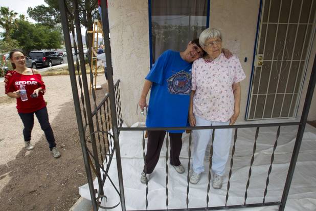 Homeowner Brenda Cox and her mother Betty, 82, watch as Keller Williams associates from the Market Place Offices work on their home near Boulder Highway and Sahara Avenue Thursday, May 9, 2013. The associates were among more than 70,000 workers around the world participating in the fifth annual Keller Williams RED Day. RED Day (Renew, Energize and Donate) is an initiative where Keller Williams associates donate a day to give back to the community.