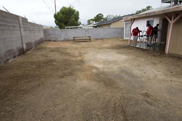 A backyard is shown clear of weeds and debri as Keller Williams associates from the Market Place Offices work on a home near Boulder Highway and Sahara Avenue Thursday, May 9, 2013. The associates were among more than 70,000 workers around the world participating in the fifth annual Keller Williams RED Day. RED Day (Renew, Energize and Donate) is an initiative where Keller Williams associates donate a day to give back to the community.