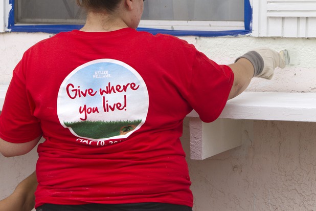 A Keller Williams associate paints a home near Boulder Highway and Sahara Avenue Thursday, May 9, 2013. The associates were among more than 70,000 workers around the world participating in the fifth annual Keller Williams RED Day. RED Day (Renew, Energize and Donate) is an initiative where Keller Williams associates donate a day to give back to the community.