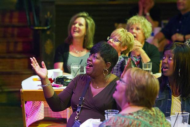 Linda Dent, center, of Birmingham, Ala. to a performance by Sharon Smith and the Nu Vision Ensemble during a Mother's Day “Kirk Franklin’s Gospel Brunch” at the House of Blues in Mandalay Bay Sunday, May 12, 2013.