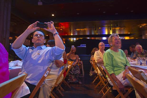 A man takes a video with his phone as Sharon Smith and the Nu Vision Ensemble perform during a Mother's Day “Kirk Franklin’s Gospel Brunch” at the House of Blues in Mandalay Bay Sunday, May 12, 2013.