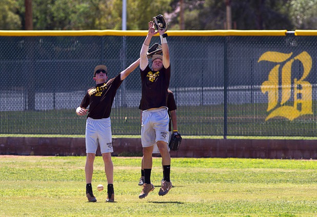 Chris Dunn, left, Brett Doyle catch balls in the outfield during batting practice at Bonanza High School Monday, May 13, 2013. Bonanza is the surprise team in the state tournament, upsetting the seven-time state champion Bishop Gorman High School twice in last week's double elimination Sunset Regional event.