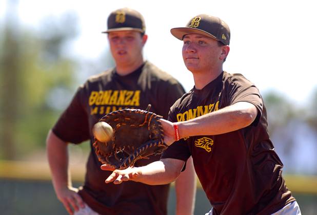 Hunter Junge, right, makes a catch as Travis Ming looks on during practice at Bonanza High School Monday, May 13, 2013. Bonanza is the surprise team in the state tournament, upsetting the seven-time state champion Bishop Gorman High School twice in last week's double elimination Sunset Regional event.
