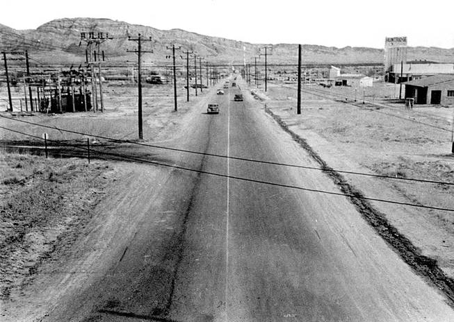 A very early photo looking east on Charleston Boulevard with the Huntridge Theater, almost completely surrounded by desert, on the far right.