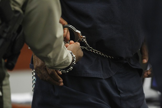 O.J. Simpson is handcuffed before leaving the courtroom for a lunch break during an evidentiary hearing in Clark County District Court Thursday, May 16, 2013. Simpson, who is currently serving a nine-to-33-year sentence in state prison as a result of his October 2008 conviction for armed robbery and kidnapping charges, is using a writ of habeas corpus to seek a new trial, claiming he had such bad representation that his conviction should be reversed.