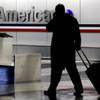 In this Nov. 29, 2011, file photo, a passenger walks through an American Airlines baggage claim area at O'Hare International Airport in Chicago. 
