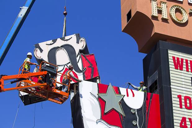Workers take down the Terribles Cowboy signage at Terribles Hotel & Casino, 4100 Paradise Rd., Monday, May 20, 2013. The property is being renamed Silver Sevens Hotel & Casino. The new name and signage is part of a $5 million renovation project by Affinity Gaming. The cowboy sign is being donated to the Neon Museum.