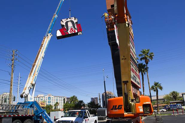 Workers take down the Terribles Cowboy signage at Terribles Hotel & Casino, 4100 Paradise Rd., Monday, May 20, 2013. The property is being renamed Silver Sevens Hotel & Casino. The new name and signage is part of a $5 million renovation project by Affinity Gaming. The cowboy sign is being donated to the Neon Museum.