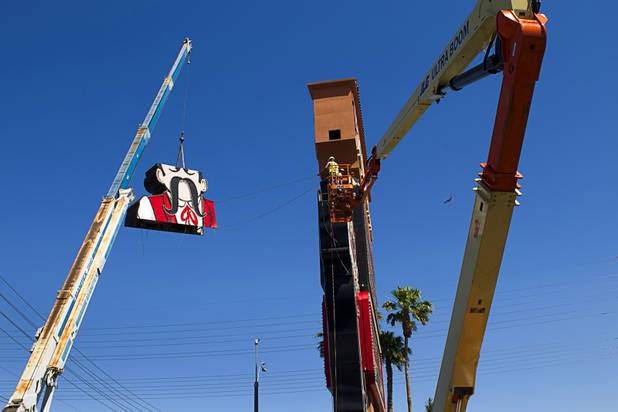 Workers take down the Terribles Cowboy signage at Terribles Hotel & Casino, 4100 Paradise Rd., Monday, May 20, 2013. The property is being renamed Silver Sevens Hotel & Casino. The new name and signage is part of a $5 million renovation project by Affinity Gaming. The cowboy sign is being donated to the Neon Museum.