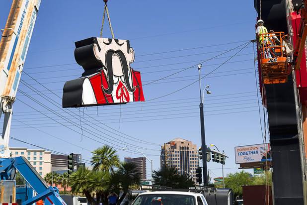 The head of the Terribles Cowboy signage is lowered to a flatbed trailer at Terribles Hotel & Casino, 4100 Paradise Rd., Monday, May 20, 2013. The property is being renamed Silver Sevens Hotel & Casino. The new name and signage is part of a $5 million renovation project by Affinity Gaming. The cowboy sign is being donated to the Neon Museum.