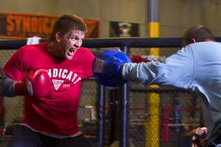 UFC welterweight fighter Mike Pyle, left, works on his timing with boxing coach Jimmy Gifford at the Syndicate gym Monday, May 20, 2013. Pyle will fight Rick Story at the MGM Grand Garden Arena Saturday.