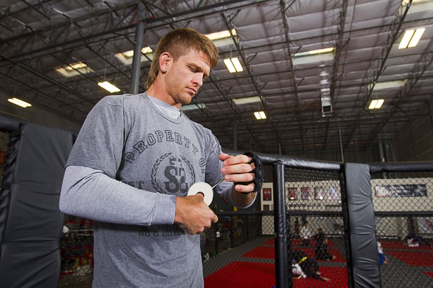 UFC welterweight fighter Mike Pyle wraps his gloves before a workout at the Syndicate gym Monday, May 20, 2013. Pyle will fight Rick Story at the MGM Grand Garden Arena Saturday.