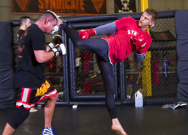 UFC welterweight fighter Mike Pyle, right, kicks at Nate Pettit as he prepares for UFC 160 at the Syndicate gym Monday, May 20, 2013. Pyle will fight Rick Story at the MGM Grand Garden Arena Saturday.