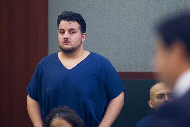 Alleged pimp Arman Izadi listens to defense attorney Michael Cristalli in District Court at the Regional Justice Center Tuesday, May 21, 2013.