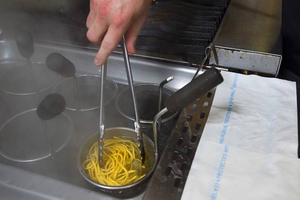 Chef Scott Conant makes spaghetti in the Scarpetta restaurant kitchen at the Cosmopolitan Wednesday, May 22, 2013.