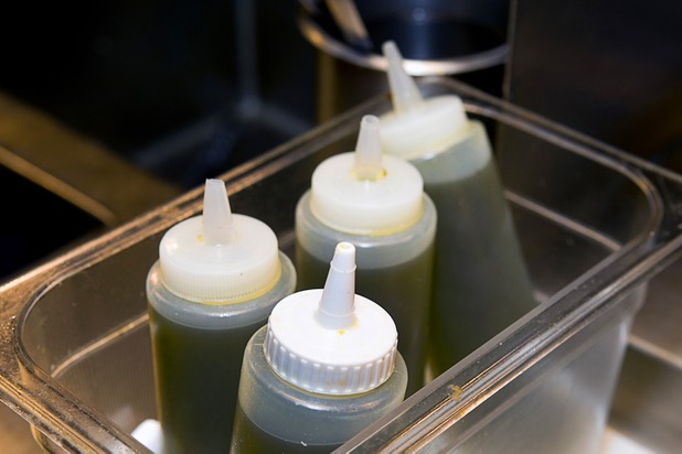 Bottles of extra virgin olive oil in the Scarpetta restaurant kitchen at the Cosmopolitan Wednesday, May 22, 2013.