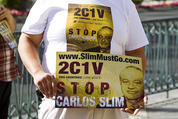 A member of Two Countries One Voice protests against Carlos Slim, a Mexican businessman listed as the second richest man in the world by Bloomberg's Billionaire Index, in front of the Venetian Wednesday, May 22, 2013. The group accuses Slim's telecommunication companies of engaging in predatory and monopolistic practices. The protest coincides with CTIA, a wireless technology convention, being held at the Sands Expo Center.