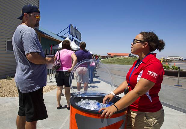 James May, left, talks with Alicia Castile as he waits in line to pick up a season pass at the Wet 'n' Wild Las Vegas water park, 7055 S. Fort Apache Road, Wednesday, May 22, 2013. The new 41-acre park opens to Gold Pass holders on Saturday. Single day tickets are available from June 3.