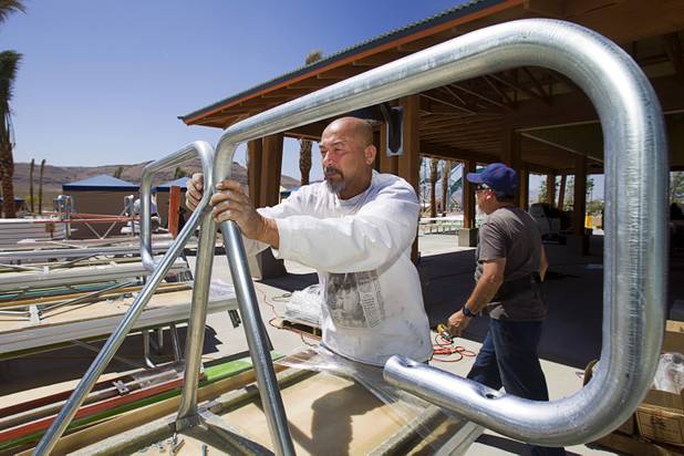 Peter Grey assembles a picnic table outside the Oasis Cafe at the Wet 'n' Wild Las Vegas water park, 7055 S. Fort Apache Road, Wednesday, May 22, 2013. The new 41-acre park opens to Gold Pass holders on Saturday. Single day tickets are available from June 3.