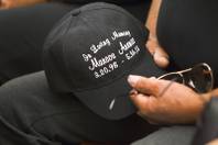 A family member holds a hat in memory of 15-year-old Marcos Arenas in Las Vegas Justice Court at the Regional Justice Center Thursday, May 23, 2013. Jacob Dismont, 18, and Michael Solid, 21, are accused of killing Arenas while trying to steal his iPad.