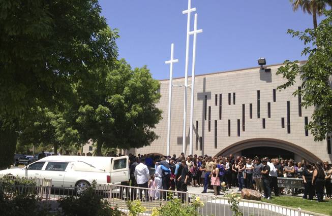 Family and Friends gather outside St Francis de sales Catholic Church on 1111 N Michael, Friday, May 24, 2013 after the funeral service for Marcos Vincente Arenas.