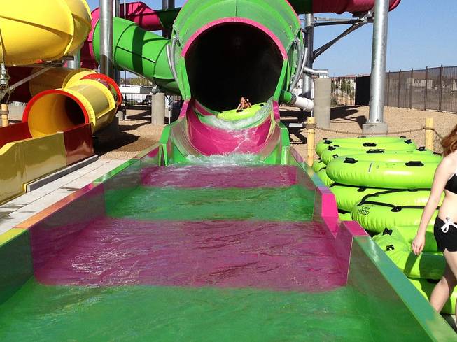 Kids tube down one of the Wet n Wild large slides during the park’s grand opening on Friday, May 24, 2013. The 41-acre water park on Fort Apache Road near the 215 Beltway was opened to visitors for the first time.