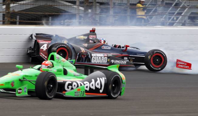 James Hinchcliffe, of Canada, bottom, goes under as JR Hildebrand hits the wall in the first turn during the Indianapolis 500 auto race at the Indianapolis Motor Speedway in Indianapolis on Sunday, May 26, 2013.