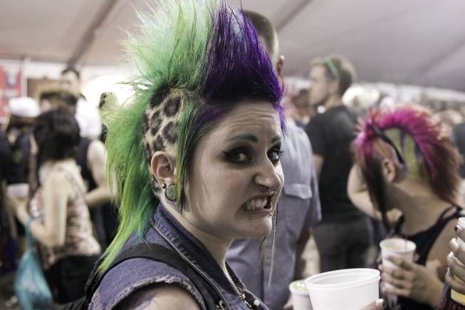 A fan with a colorful mohawk hangs out at the beer canopy at the Punk Rock Bowling & Music Festival, Sunday, May 26, 2013.