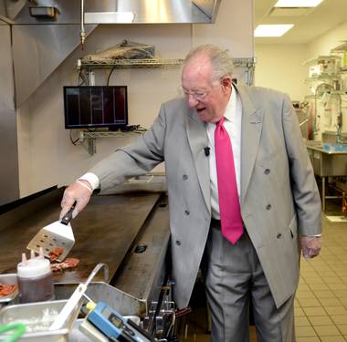 Burgermeister and former Las Vegas Mayor Oscar Goodman works the grill at Smashburger to celebrate National Burger Day on Tuesday, May 28, 2013.