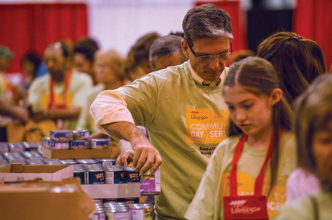 Nevada Rep. Joe Heck helps fill grocery bags to fill the elderly Saturday, June 1, 2013.