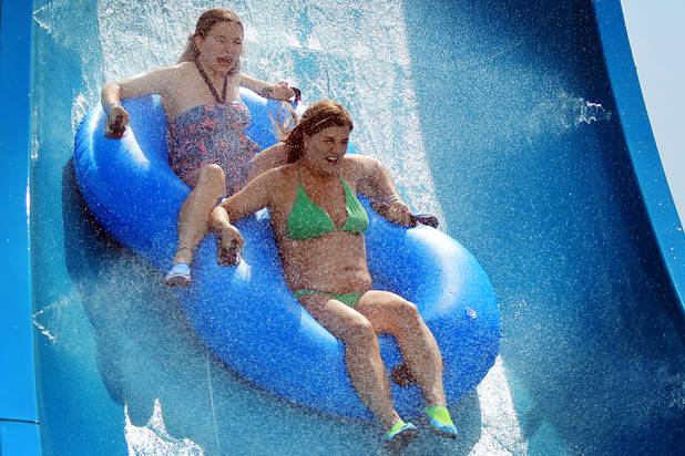Lola DeLong, 14, left, and Tasha Ray, 24, both of St. George, ride the Hoover Half Pipe during the first day of general admission at Wet'n'Wild Las Vegas on Monday, June 3, 2013.