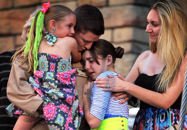 U.S. Air Force Capt. John Costa surprises his daughters by appearing at the end of the "Sirens of TI" show at Treasure Island in Las Vegas on Tuesday, June 4, 2013. Costa was deployed for a year-long tour in Afghanistan.