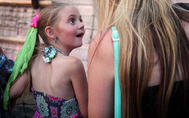 Tally Costa, 6, reacts when she hears her father, U.S. Air Force Capt. John Costa, announced on stage at the end of the "Sirens of TI" show at Treasure Island in Las Vegas on Tuesday, June 4, 2013. Costa was deployed for a year-long tour in Afghanistan.